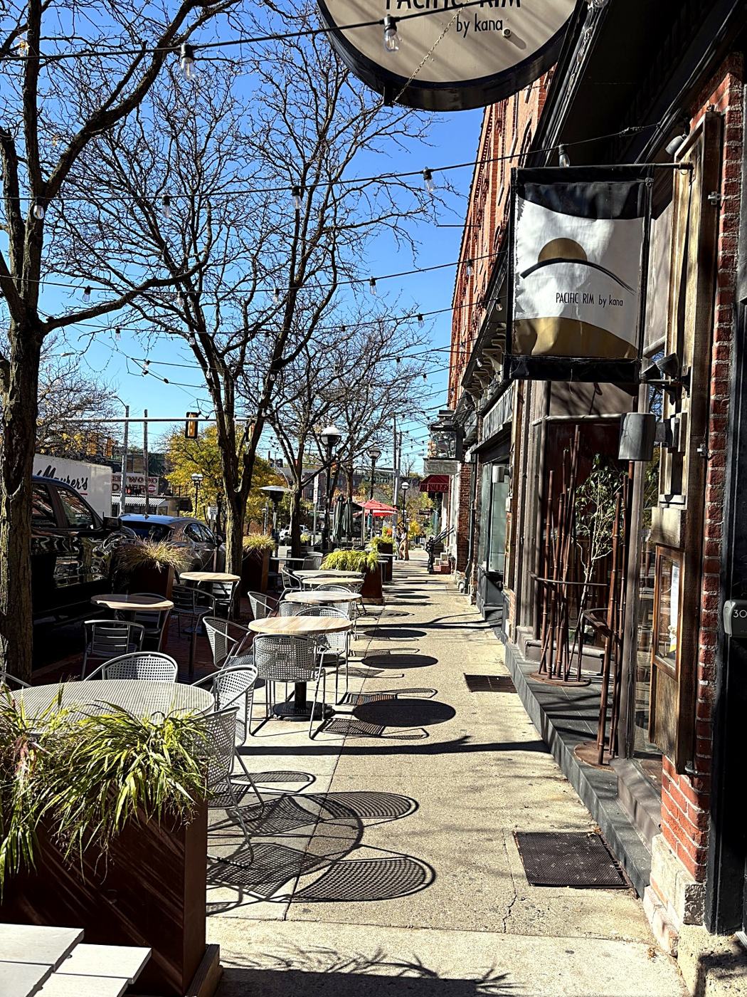Café tables along a Main Street sidewalk in Ann Arbor